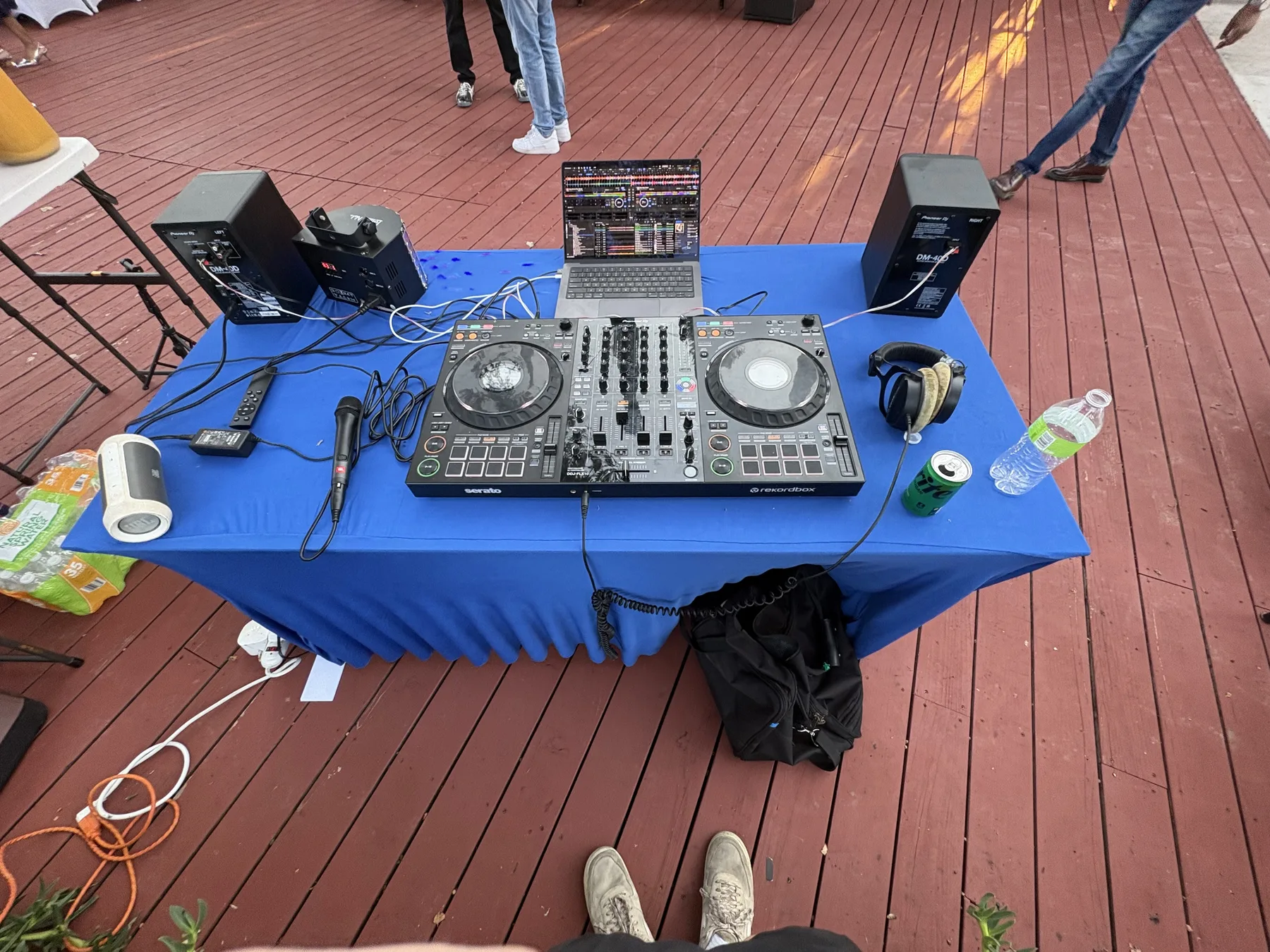 DJ controller, laptop, speakers, and microphone set up for a party